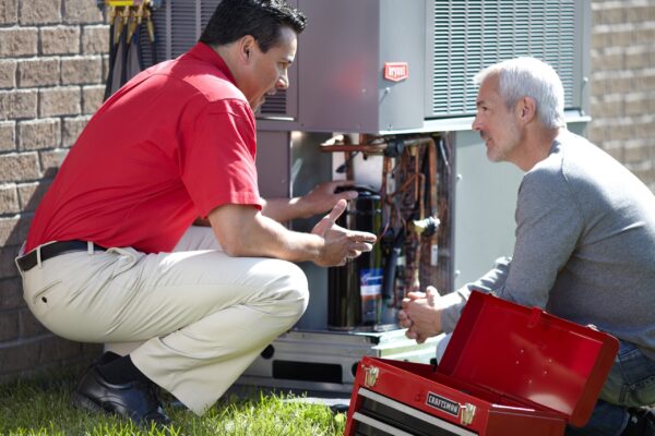 HVAC Technician Explaining AC Maintenance to Customer in Fieldale, VA